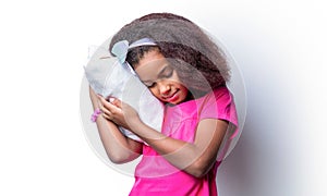 Healthy baby& x27;s sleep. Children girl is sleeping a pillow on a white background. African kid girl sleeps in cushion