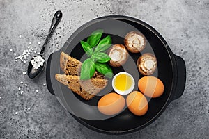 Healthy balanced breakfast ingredients. Egg, mushrooms, mushrooms, herbs, herbs, bread, olive oil, salt for cooking