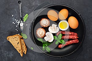 Healthy balanced breakfast ingredients. Egg, mushrooms, mushrooms, herbs, herbs, bread, olive oil, salt for cooking