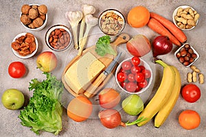 Healthy balanced diet with dietary ingredients, vegetables, fruits, nuts and cheese for weight loss, source of vitamin C, healthy