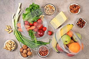 Healthy balanced diet with dietary ingredients, vegetables, fruits, nuts and cheese for weight loss, source of vitamin C, healthy