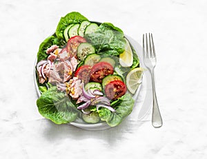 Healthy balanced diet  food - canned tuna, tomatoes, cucumbers, lettuce, red onion, olive oil salad for appetizer, lunch, tapas