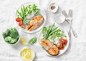 Healthy balanced mediterranean diet lunch - baked salmon, rice, green peas and green beans on a light background, top view.