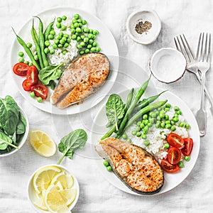 Healthy balanced mediterranean diet lunch - baked salmon, rice, green peas and green beans on a light background, top view