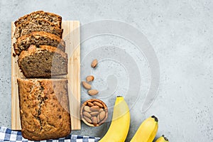 Healthy banana bread loaf on concrete background top view