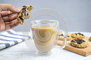 Healthy banana oatmeal cookies with chocolate, healthy dessert and coffee with milk for breakfast