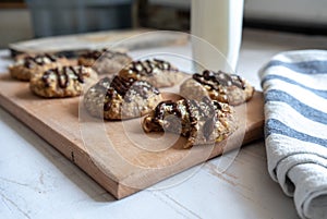 Healthy banana oatmeal cookies with chocolate, healthy dessert with milk for breakfast