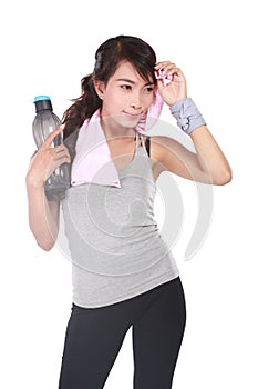 Healthy beautiful sportswoman wearing tracksuit with towel and holding bottle with fresh water
