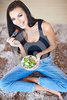 Healthy beautiful woman eating fresh salad