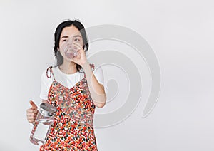 Healthy beautiful young Asian woman, drinking water, on white background