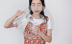 Healthy beautiful young Asian woman, pouting fresh water on drinking glass