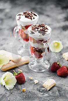 Healthy berry dessert. Strawberry trifle with strawberries, whipped cream and bisquits in glasses