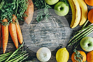 Healthy bio food ingredients frame background from above. Top view of organic superfood border on rustic wooden table. Colorful