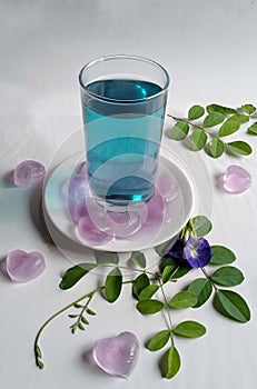 Healthy blue butterfly flower drink with ice cubes