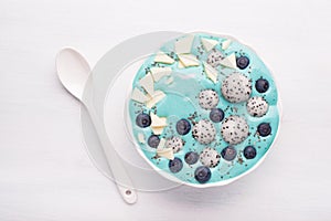 healthy blue spirulina smoothie bowl with blueberry, white chocolate, dragon fruit, chia seed