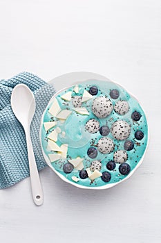 healthy blue spirulina smoothie bowl with blueberry, white chocolate, dragon fruit, chia seed