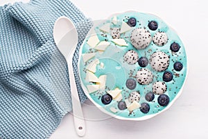 healthy blue spirulina smoothie bowl with blueberry, white chocolate, dragon fruit, chia seed