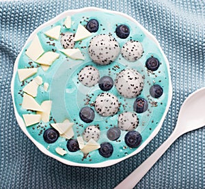 healthy blue spirulina smoothie bowl with blueberry, white chocolate, dragon fruit, chia seed