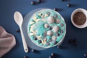 healthy blue spirulina smoothie bowl with blueberry, white chocolate, dragon fruit, chia seed