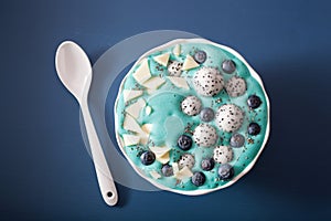 healthy blue spirulina smoothie bowl with blueberry, white chocolate, dragon fruit, chia seed