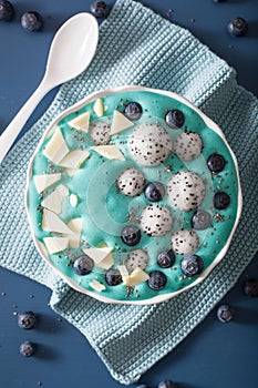 healthy blue spirulina smoothie bowl with blueberry, white chocolate, dragon fruit, chia seed