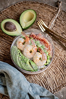 Healthy bowl with rice, avocado, shrimps, edamame and salmon