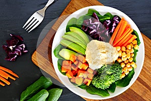 Healthy bowl with super-foods on slate background