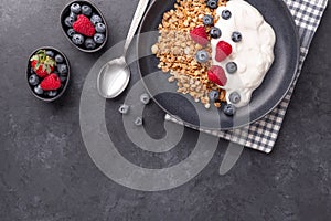 Healthy breakfast with baked granola and greek yogurt. Assorted fresh berries