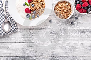Healthy breakfast with baked granola and greek yogurt. Assorted fresh berries