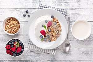 Healthy breakfast with baked granola and greek yogurt. Assorted fresh berries