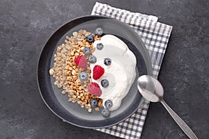 Healthy breakfast with baked granola and greek yogurt. Assorted fresh berries