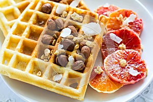 Healthy breakfast. Belgian waffles with nuts and sicilian oranges