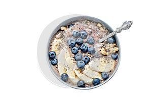 Healthy breakfast berry smoothie bowl topped with banana, granola, Blueberries and chia seeds with copy space