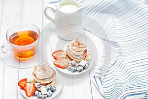 Healthy breakfast, black tea and homemade pancakes with fresh berries