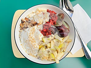 Healthy breakfast bowl with fresh fruit and superfood goji berries and chia seeds