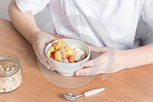 Healthy breakfast bowl in hands
