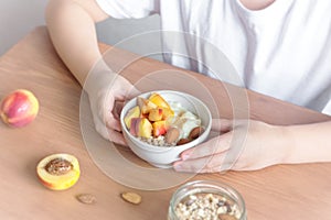 Healthy breakfast bowl in hands