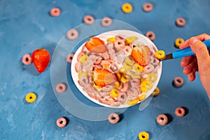 Healthy breakfast with cereal and berries. From above of bowl with delicious healthy breakfast made with colorful cereal