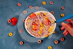 Healthy breakfast with cereal and berries. From above of bowl with delicious healthy breakfast made with colorful cereal