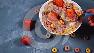 Healthy breakfast with cereal and berries. From above of bowl with delicious healthy breakfast made with colorful cereal