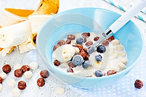 Healthy breakfast - cereal chocolate balls with milk, berries an