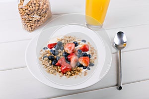 Healthy breakfast cereal with milk and fresh berries