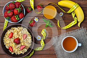 Healthy breakfast: cereals, strawberries, banana and a glass of