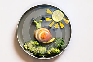 Healthy breakfast for children, creative ideas from fruit and vegetables, vitamins on plate