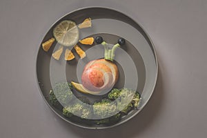 Healthy breakfast for children, creative ideas from fruit and vegetables, vitamins on plate