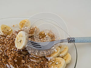 Healthy breakfast, close up of sliced bananas with cinnamon and oats.