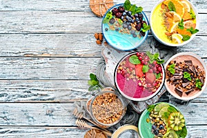 A healthy breakfast. Colorful fruit smoothies with yogurt, fresh fruit and berries. Top view. Free space for your text.