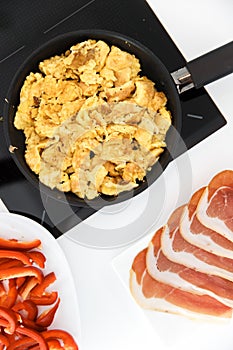 Healthy Breakfast Concept. Appetizing Omelet in a Pan, next to Sliced Bacon and Pepper