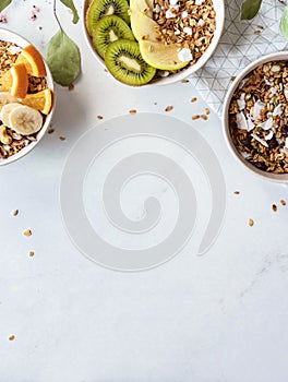 Healthy breakfast concept, cereal granola food with fruits in bowl, top view