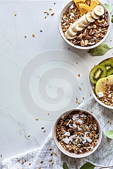 Healthy breakfast concept, cereal granola food with fruits in bowl, top view